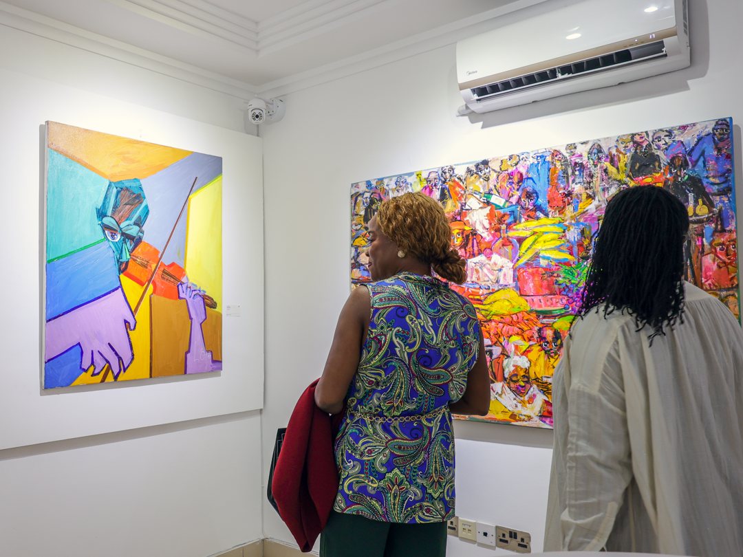 Guests in front of a cubist violinist and a busy feast scene